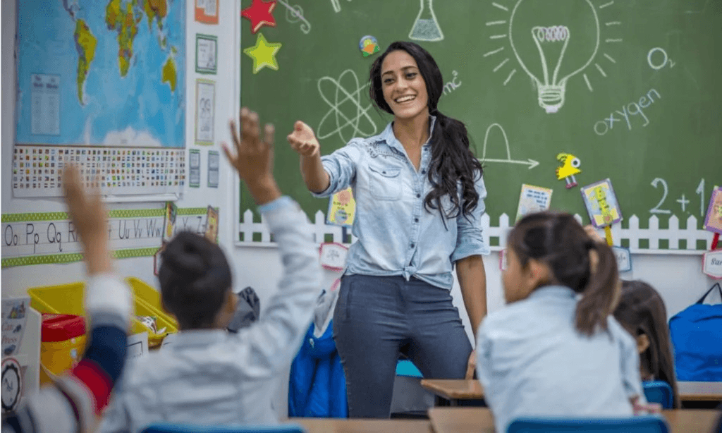 Science teacher running a hands-on experiment with young learners